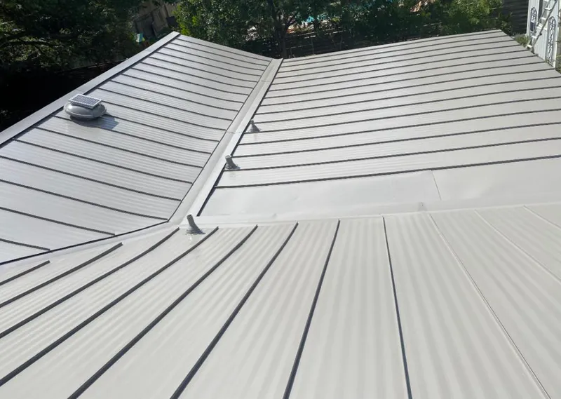 Solar attic fan installed on a metal roof for Roof Ventilation in Ellington
